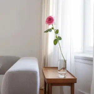 Single pink rose in glass vase