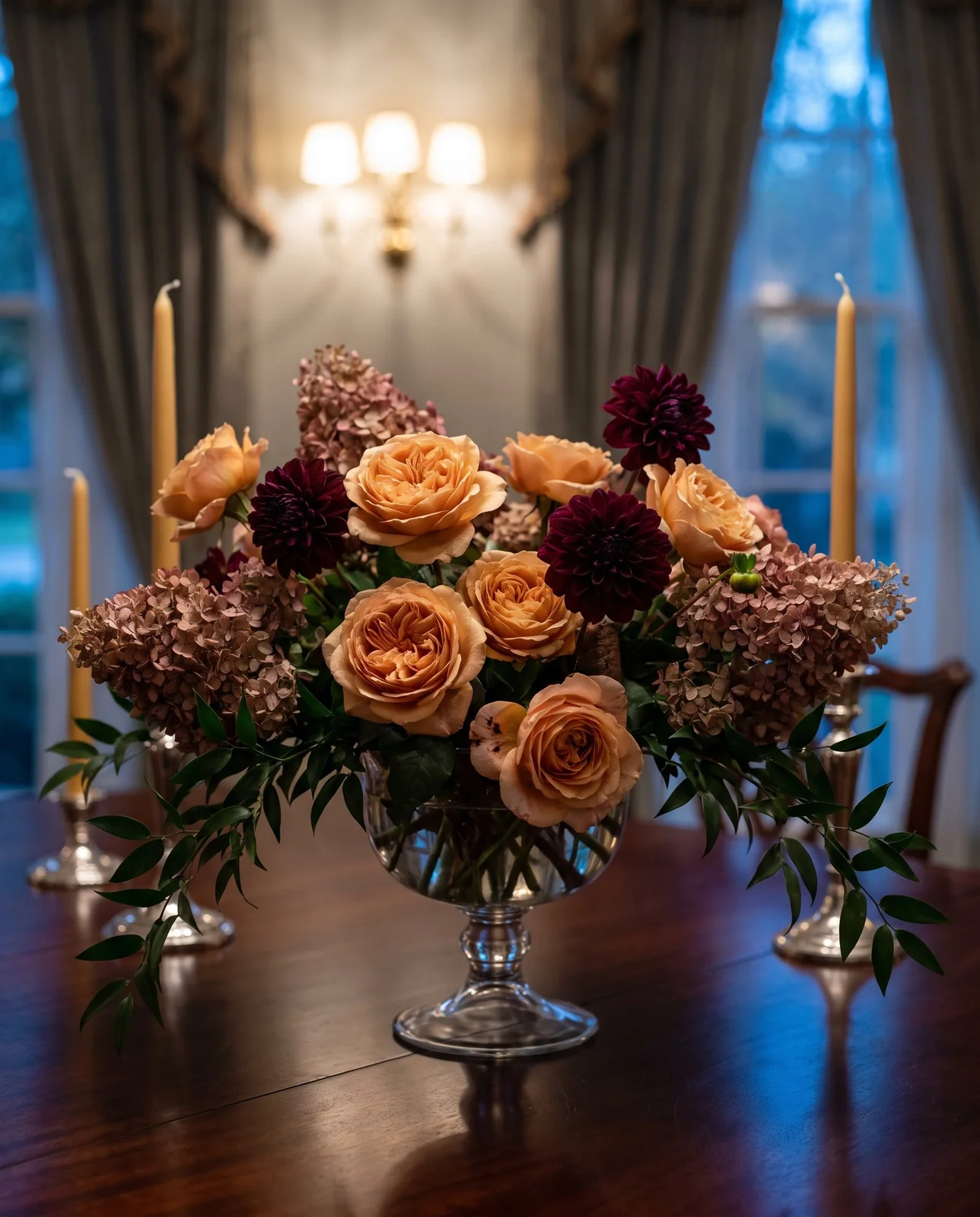 Florist compote centerpiece with garden roses and hydrangeas on mahogany table