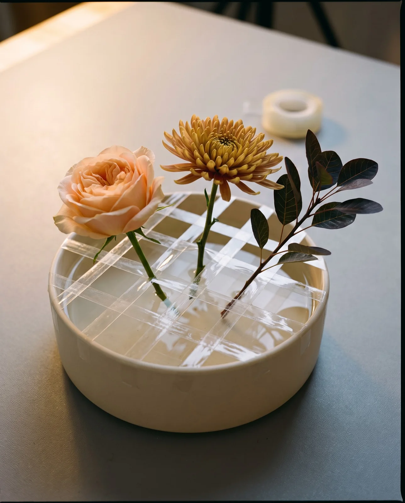Clear waterproof tape grid on a ceramic bowl for Thanksgiving centerpiece